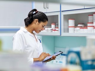 Scientist woman using digital tablet in hospital