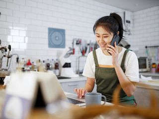 Woman working and talking on cell phone