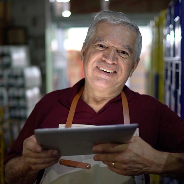 Man holding a tablet and working at a warehouse