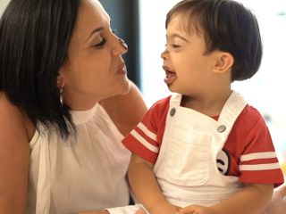 mom and child with down syndrome having fun while eating chocolate