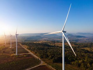 Wind energy engines with a blue sky behind