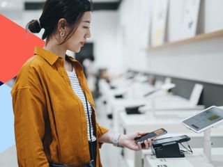  woman using contactless payment via smartphone