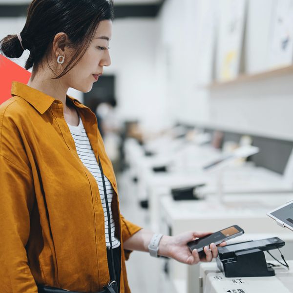  woman using contactless payment via smartphone